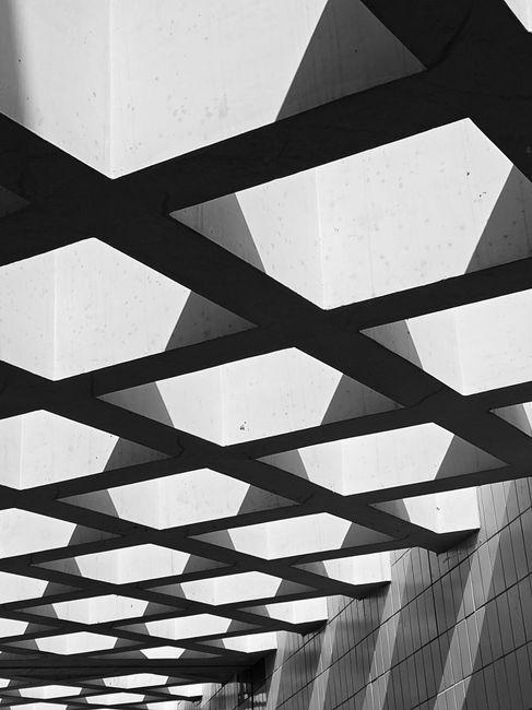 A modernist grid of concrete and shadow, suggesting foundation.