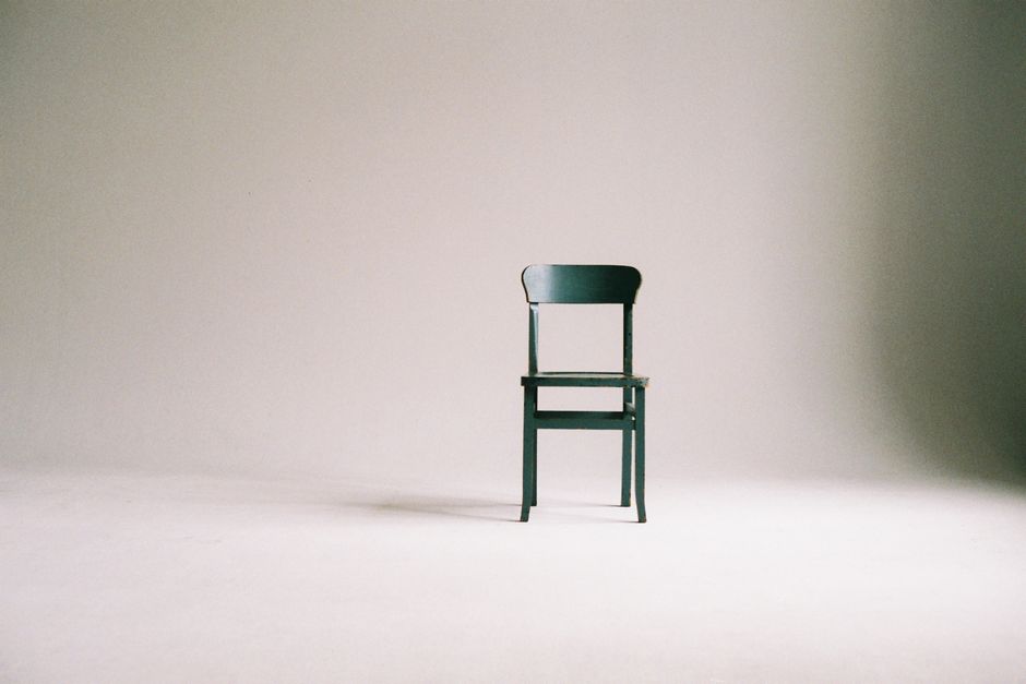 A single chair, alone in a quiet room.